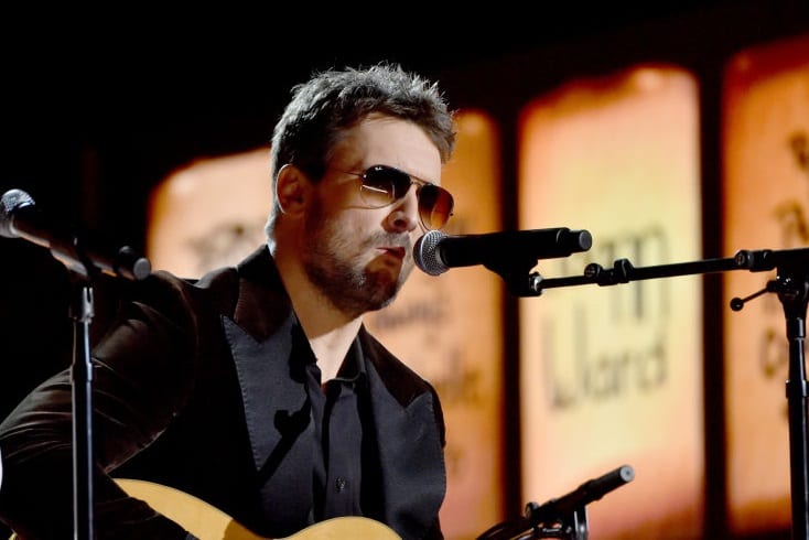 Eric Church with glasses and a microphone
