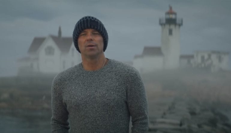 Kenny Chesney standing in front of a lighthouse