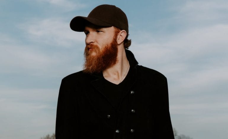 Eric Paslay with a beard and a hat