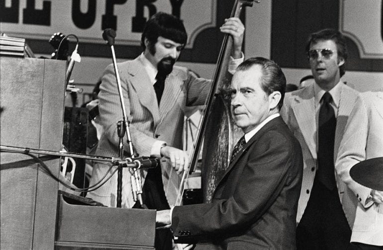 Richard Nixon holding a microphone
