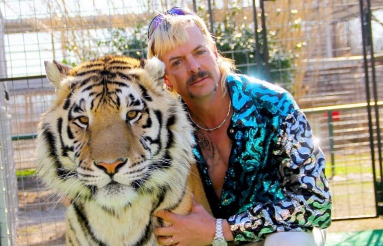 A person holding a tiger