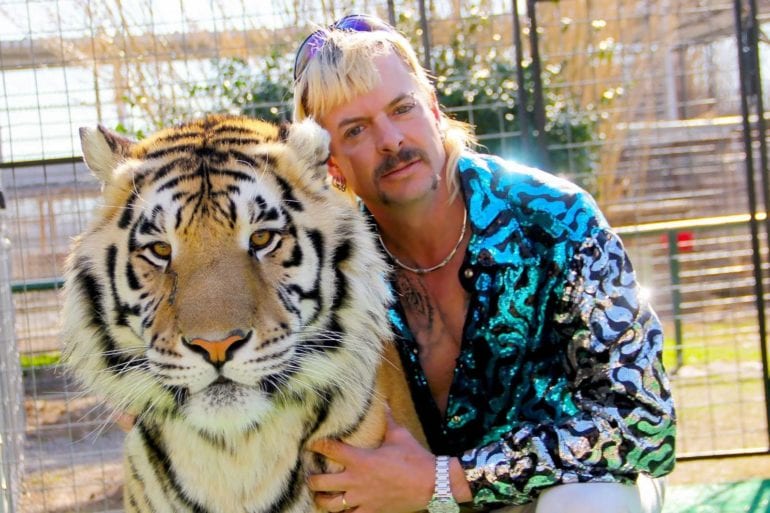 A person holding a tiger