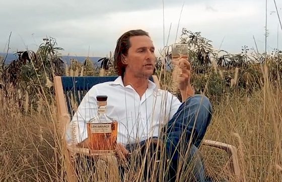 Matthew McConaughey sitting in a chair in a field of tall grass