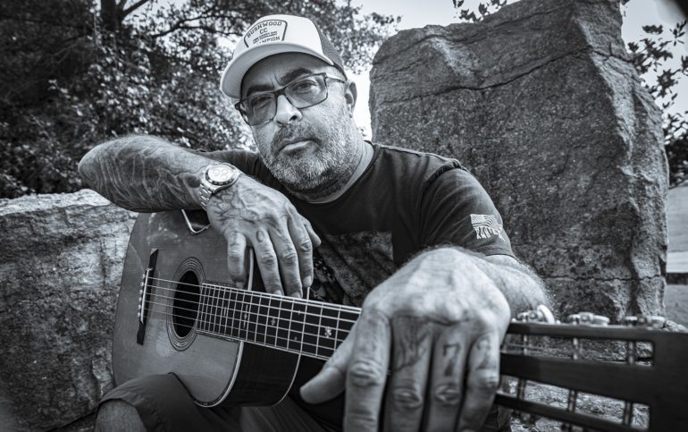 Aaron Lewis with his hand on another man's shoulder