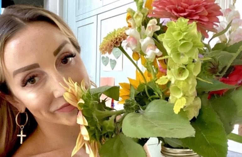 Ashley Monroe taking a selfie with a bouquet of flowers