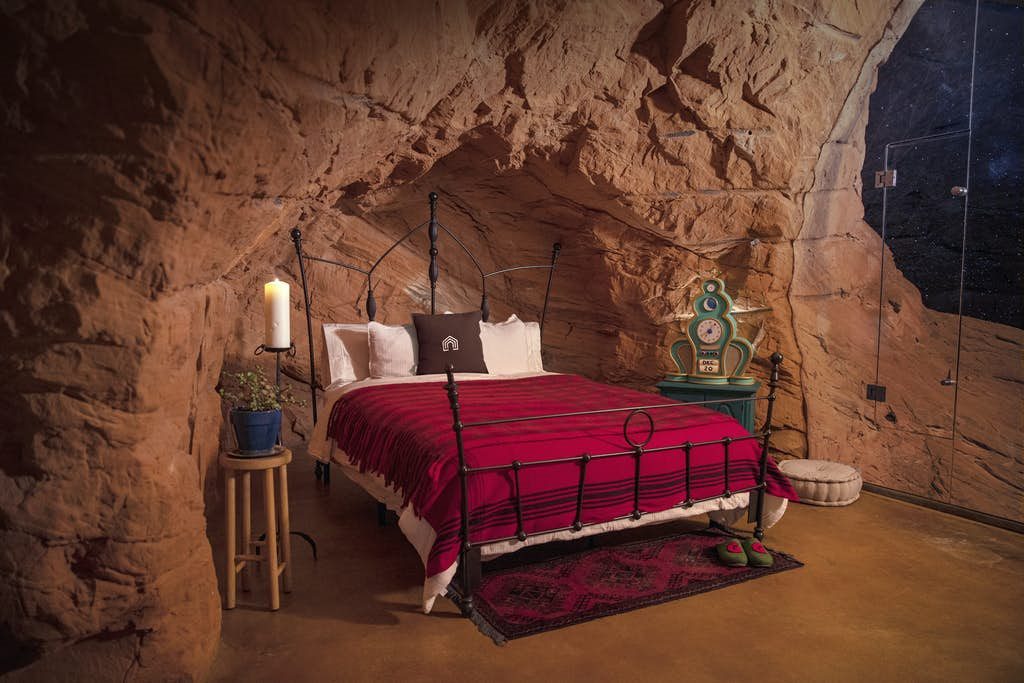 A bed in a stone room