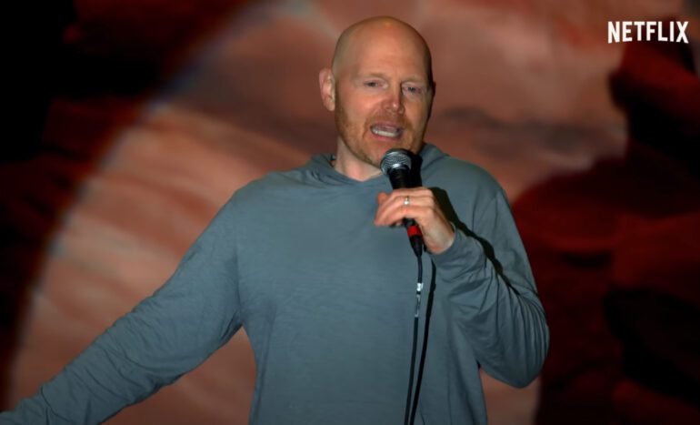 Bill Burr speaking into a microphone