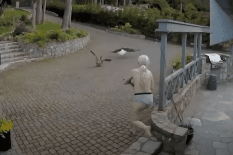 Woman with baby chasing after eagle