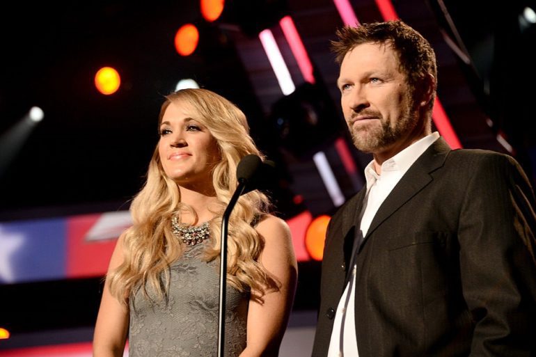 Craig Morgan, Carrie Underwood are posing for a picture