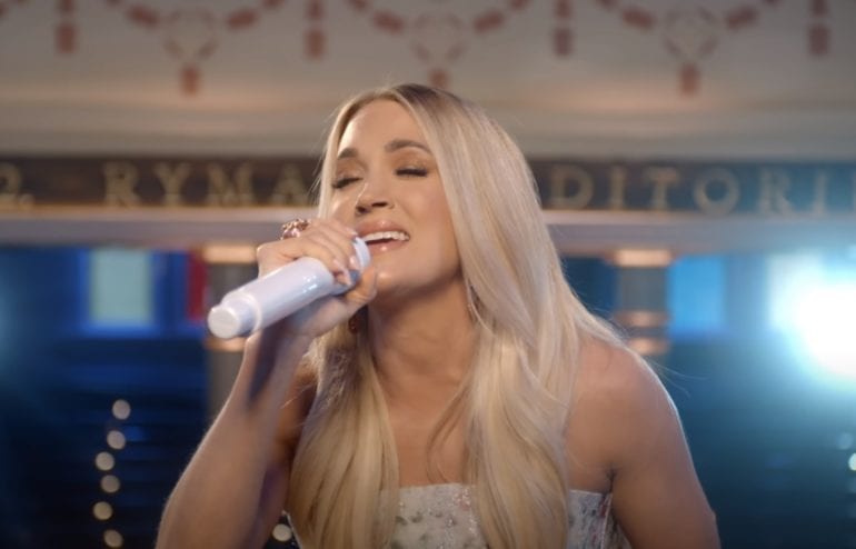 Carrie Underwood drinking from a bottle