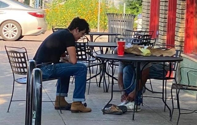 A person sitting at a table outside