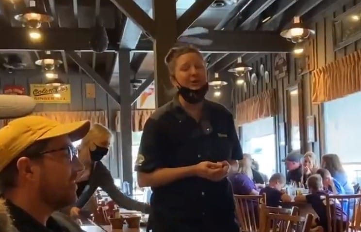 A person with a mustache and a beard in a restaurant