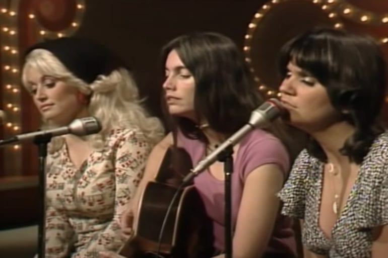 A group of women singing into a microphone