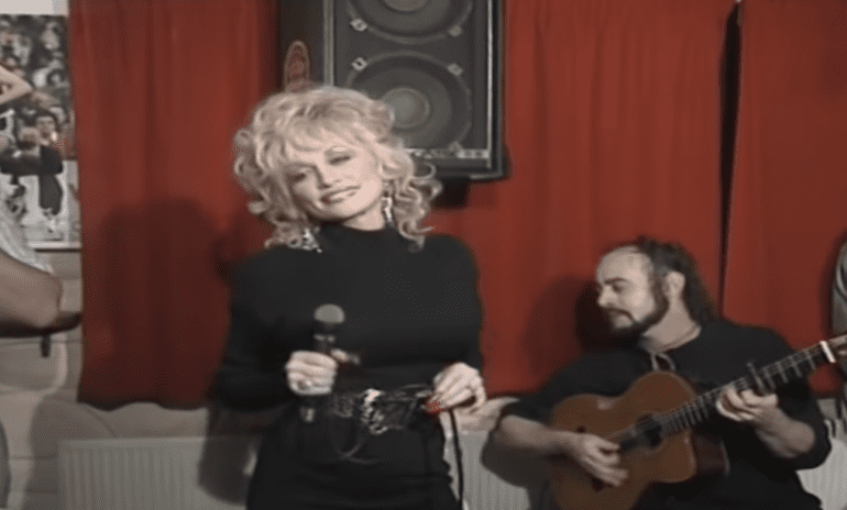 Dolly Parton playing a guitar