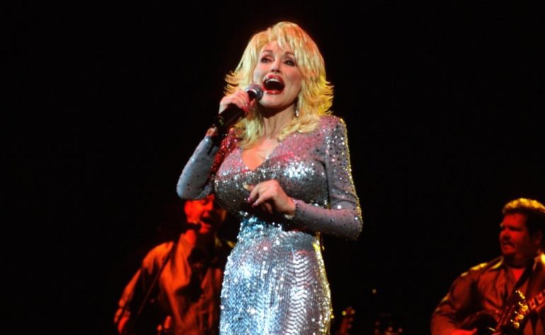 Dolly Parton singing into a microphone