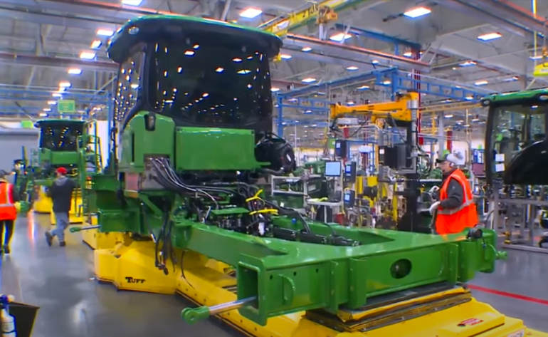 A large green machine in a factory