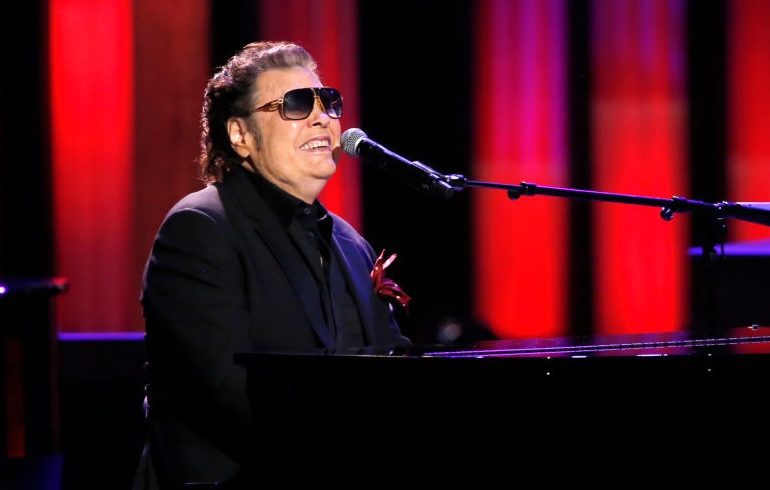 Ronnie Milsap wearing sunglasses and a suit and tie