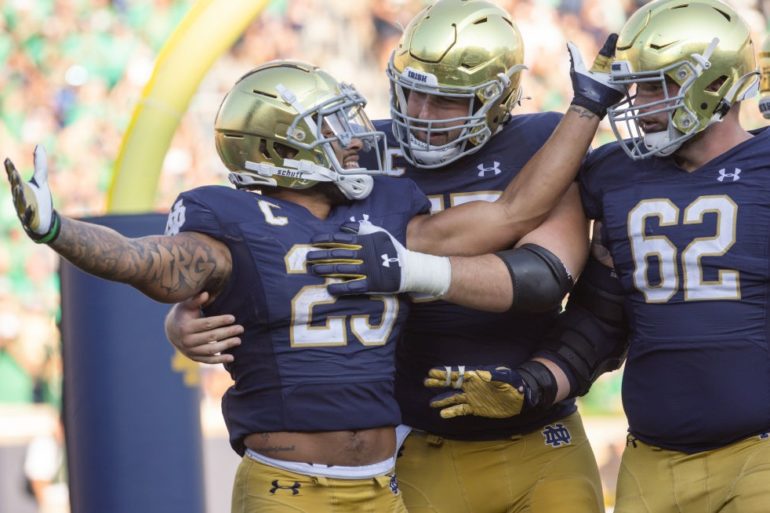 A group of people wearing football helmets