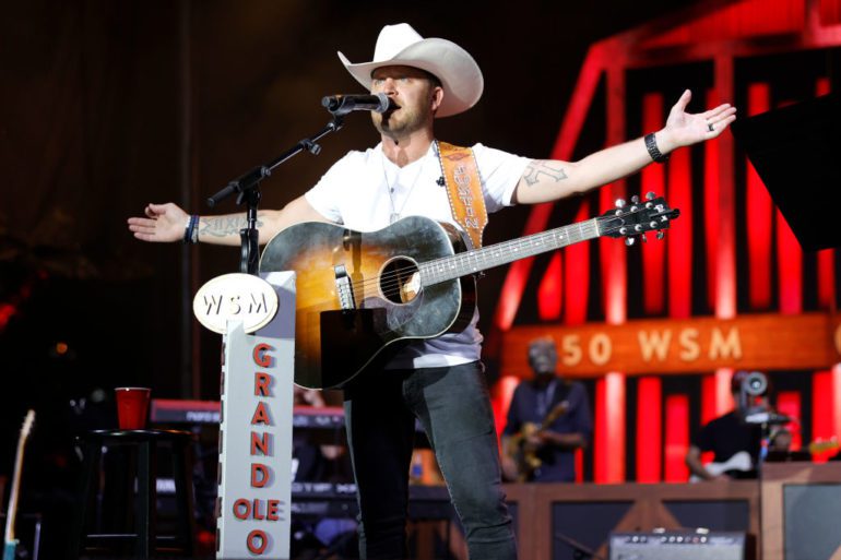 A person playing a guitar on a stage