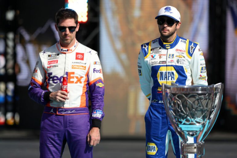 Two men wearing race cars