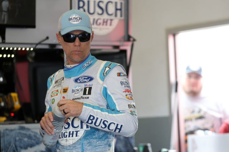 Kevin Harvick in a uniform holding a bottle of water