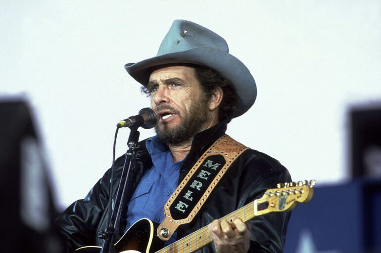 Merle Haggard with a guitar