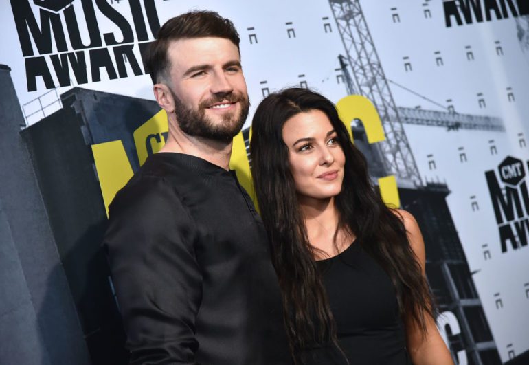 Sam Hunt and woman posing for a picture