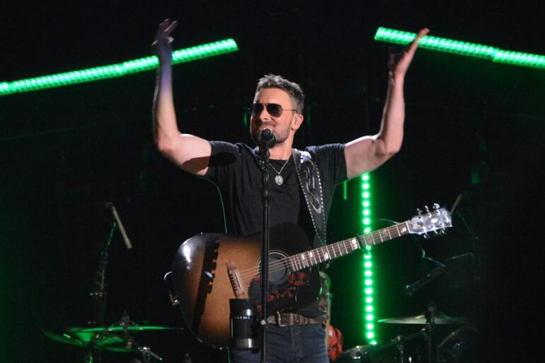 Eric Church with a guitar on a stage