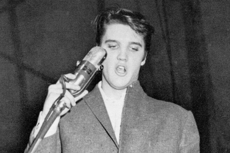 Elvis Presley holding a bottle