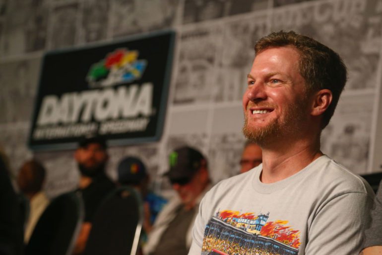 Dale Earnhardt Jr. smiling in front of a crowd