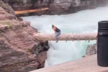 A person climbing a waterfall