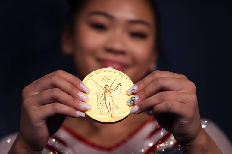 A person holding a gold coin