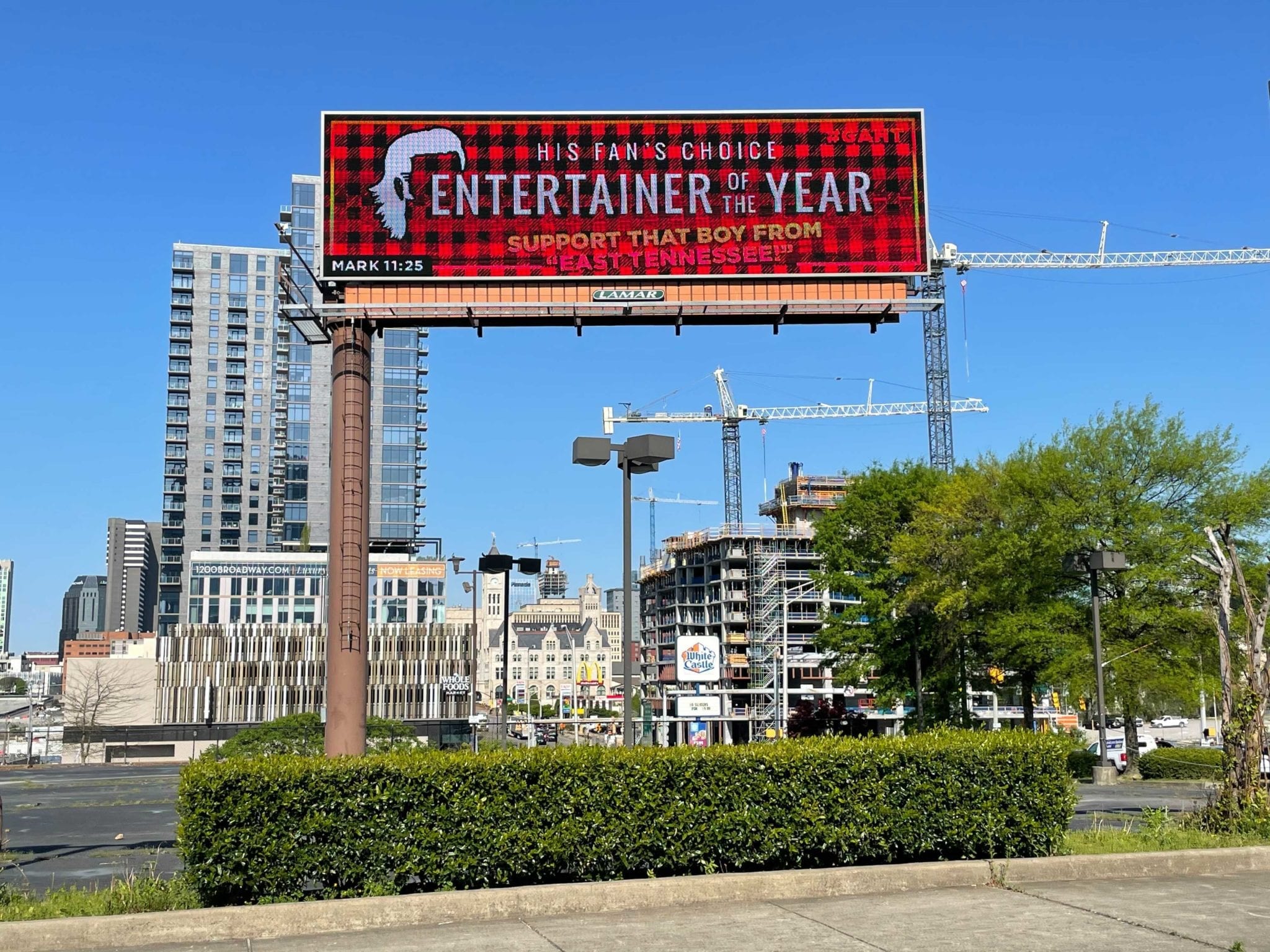 A large red sign with a city skyline in the background