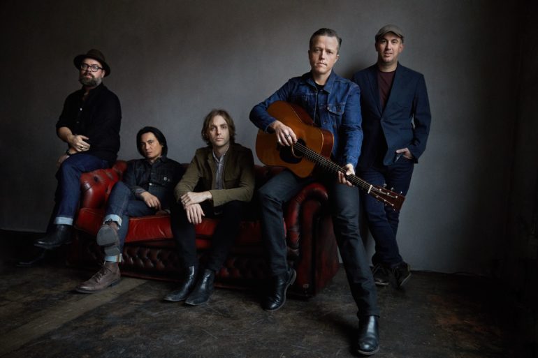 Jason Isbell et al. sitting on a couch with a guitar