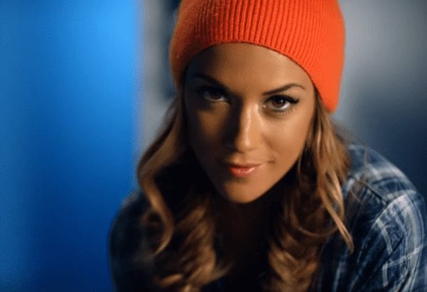 Jana Kramer with long hair wearing a red hat