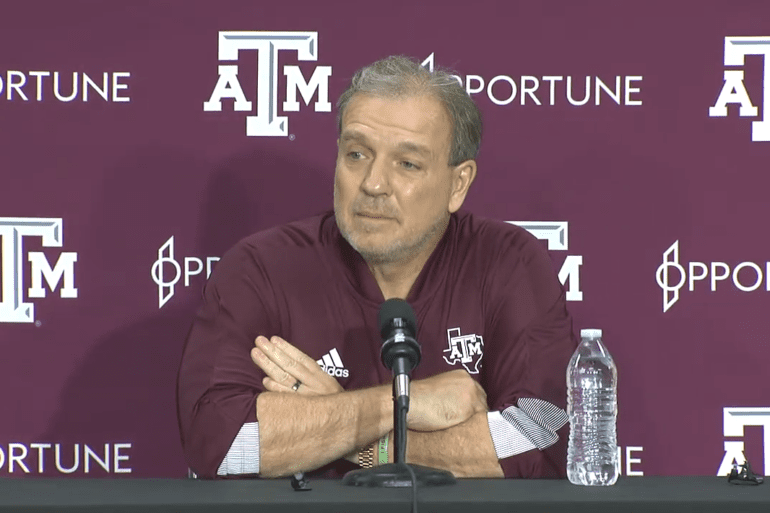Jimbo Fisher sitting at a table