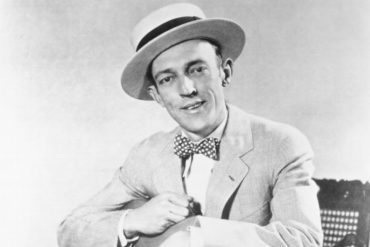 Jimmie Rodgers wearing a hat and a suit and tie