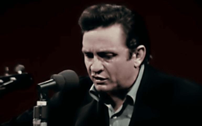 Johnny Cash speaking into a microphone