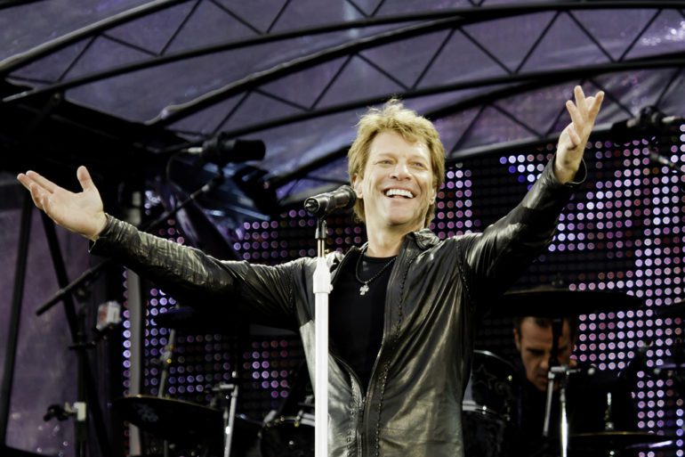 Jon Bon Jovi with his arms raised