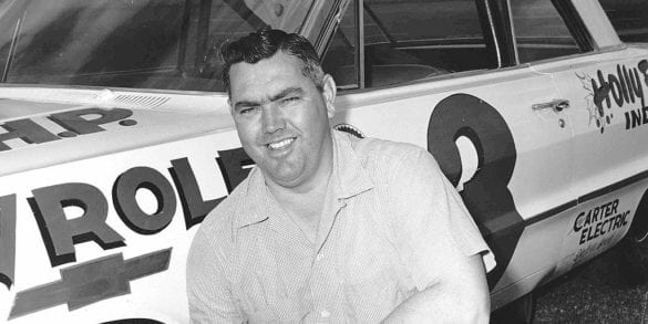 Junior Johnson standing in front of a plane
