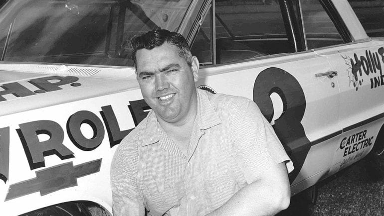 Junior Johnson standing in front of a plane