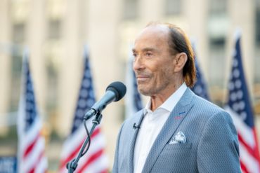 Lee Greenwood speaking into a microphone