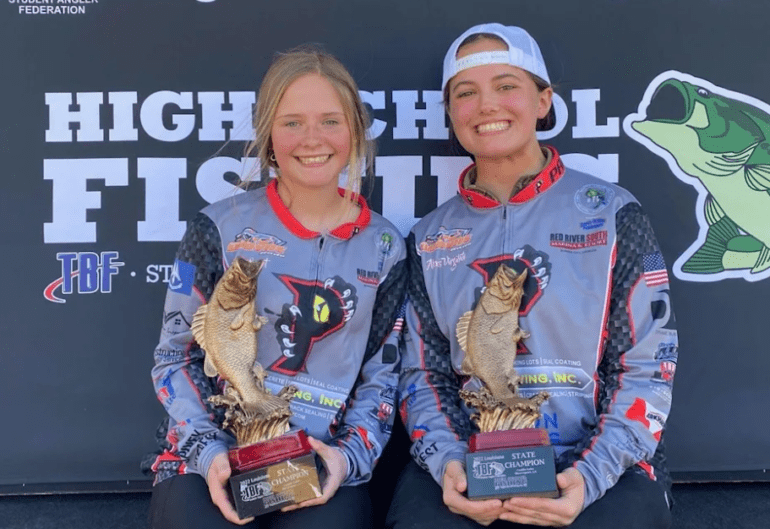 A couple of women holding trophies
