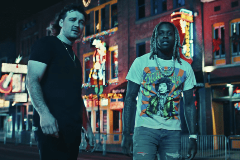 Lil Durk et al. standing in front of a store