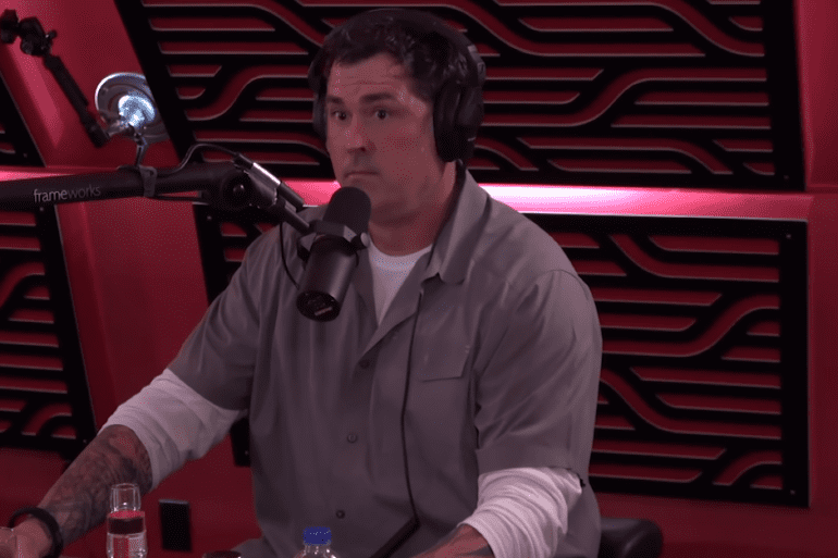 Marcus Luttrell sitting in front of a microphone