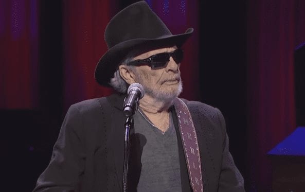 Merle Haggard wearing a hat and sunglasses