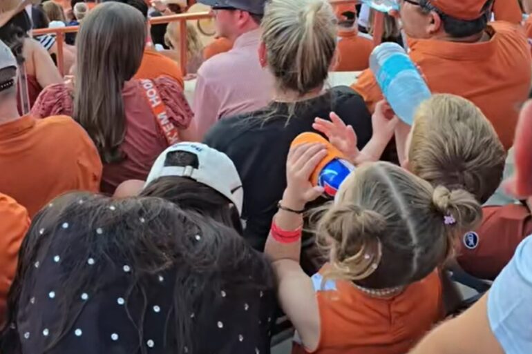 Texas fan drinks a beer