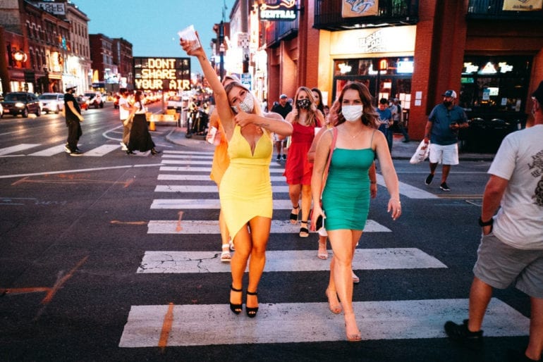 A couple of women crossing a street