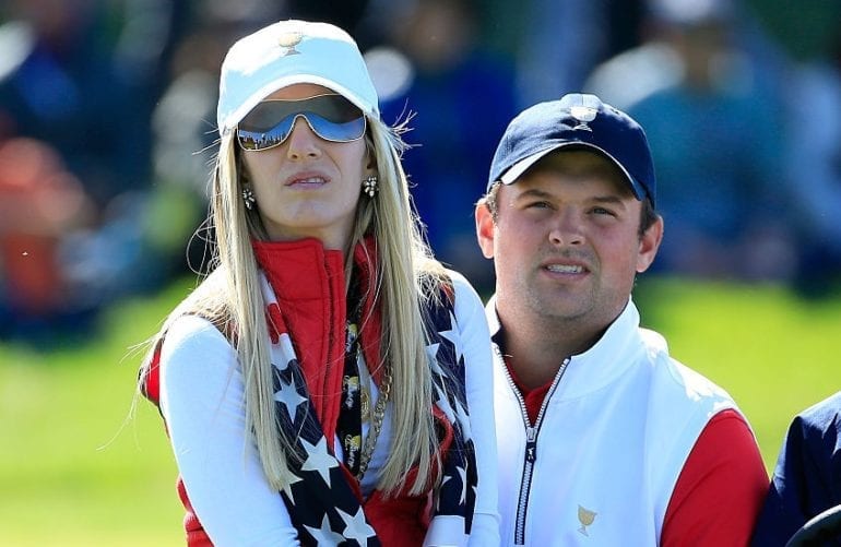 Patrick Reed and woman wearing white shirts and blue hats