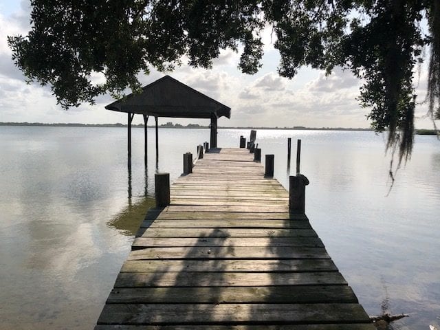 A dock with a umbrella over it
